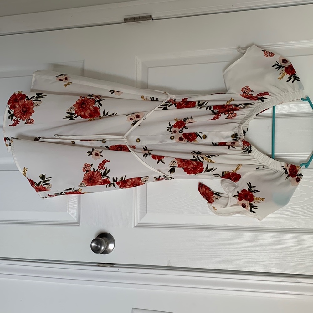 The dress is a soft white with beautiful red and pink flowers from rue21.